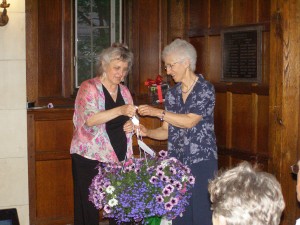 SOLF board member Deborah Costine presenting a basket of flowers to retiring board member Carol Gay for 25 years of service to SOLF.